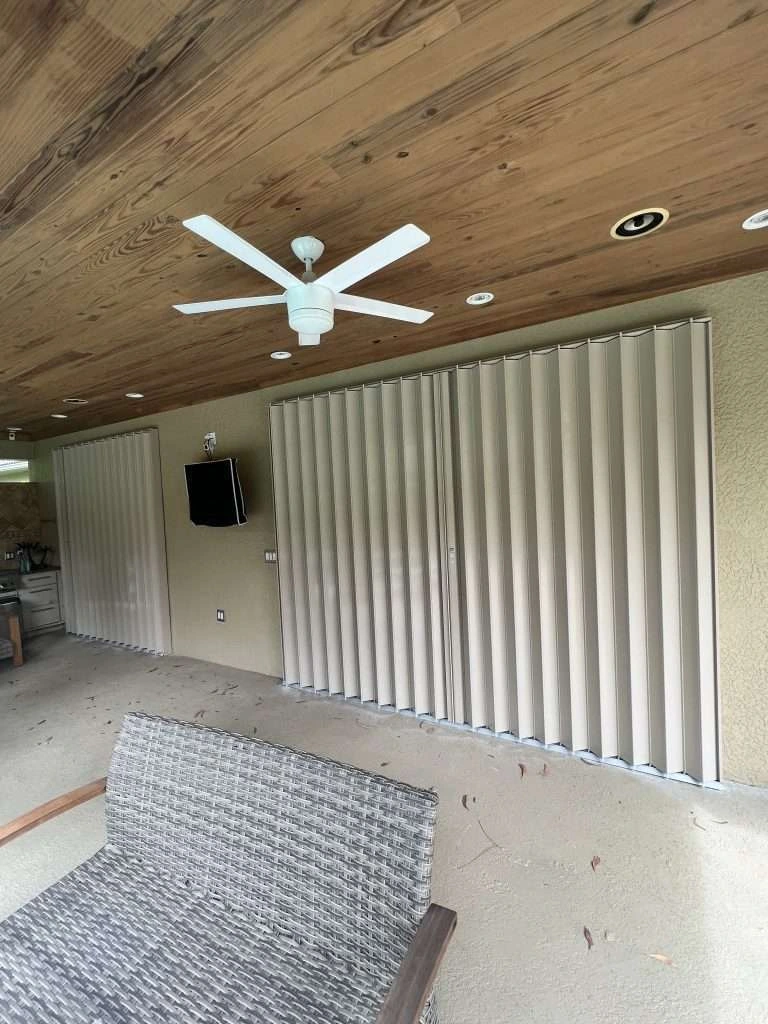 Accordion hurricane shutters installed on a lanai door in Naples Florida