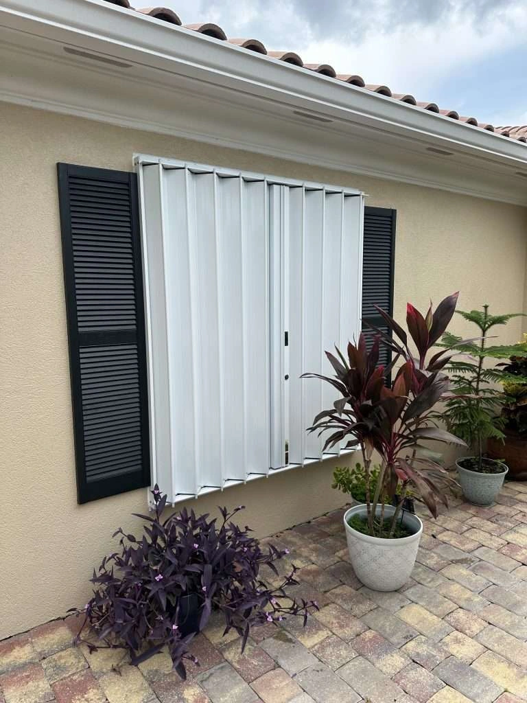 Accordion hurricane shutters installed on a Naples, Florida home for storm protection.