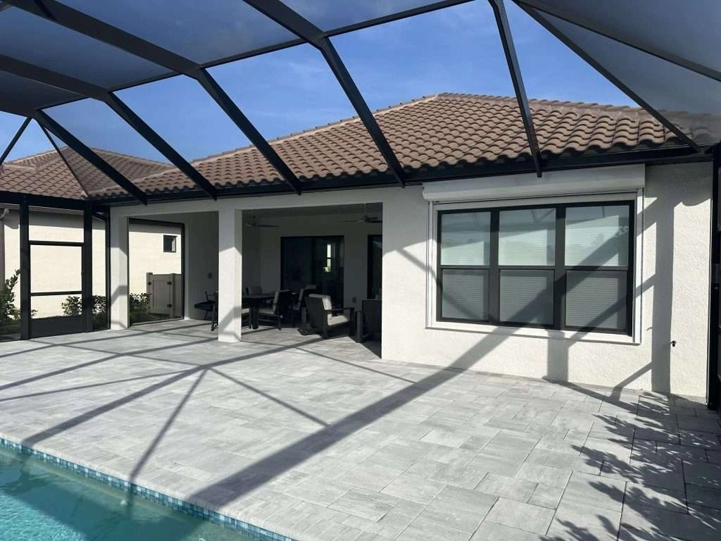 Motorized roll-down hurricane shutters protecting large lanai doors in Marco Island